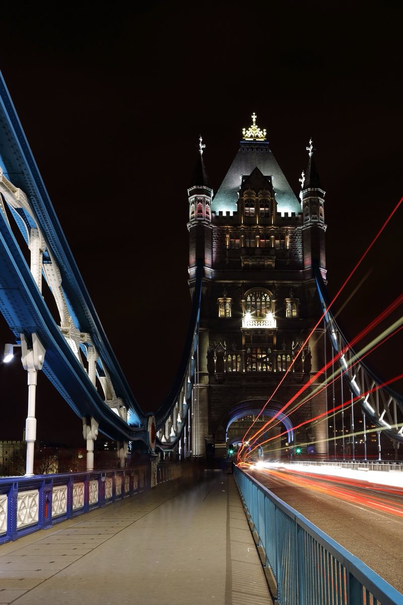 The lit towers of the Tower Bridge at night